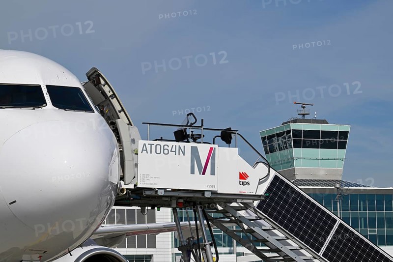 Airbus aircraft at check-in position with solar passenger stairs, control tower, satellite, Terminal 2, Munich Airport, Upper Bavaria, Bavaria, Germany, Europe