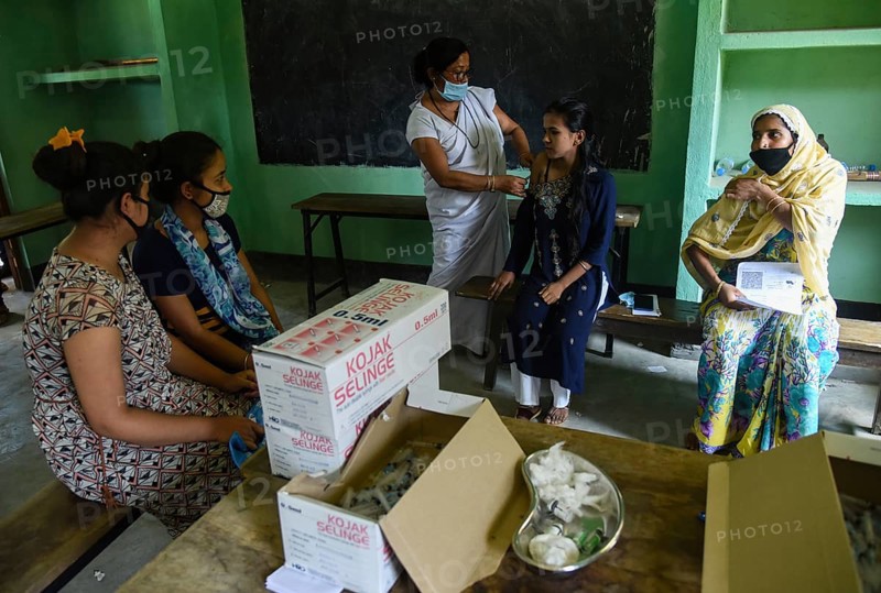 Beneficiaries receives dose of COVID-19 coronavirus vaccine in a vaccination centre at a village in Barpeta, Assam, India on 20 September 2021