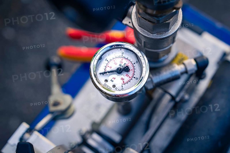 A detailed view of a round pressure gauge on a machine, glass fibre construction, Nagold, Black Forest, Germany, Europe