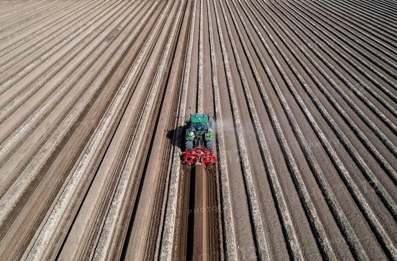 A farmer builds asparagus ridges on a field with the help of an asparagus tiller, in which the asparagus then grows, Dormagen, North Rhine-Westphalia, Germany, Europe
