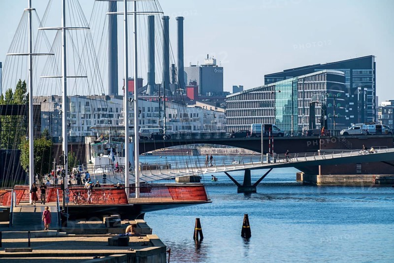 Cyclists on the Cirkelbroen cycle and footpath bridge, over the harbour, in the Christianshavens district, in the background the Sydhavnen district, the Lille Langebro bridges, Copenhagen is considered the cycling capital of the world, 45% of the population travel by bike, Denmark, Europe