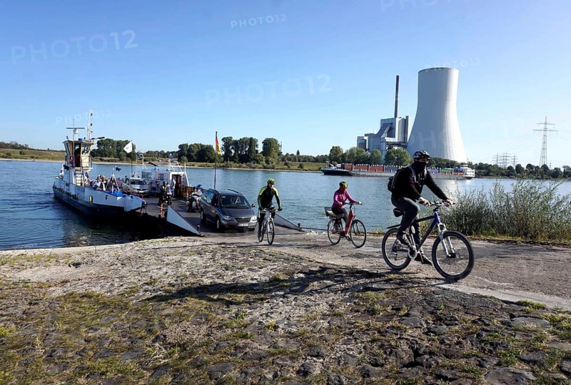 Cyclists have crossed the Rhine in Duisburg using the Walsum-Orsoy Rhine ferry, with the Duisburg Walsum power station visible in the background, 20/09/2020