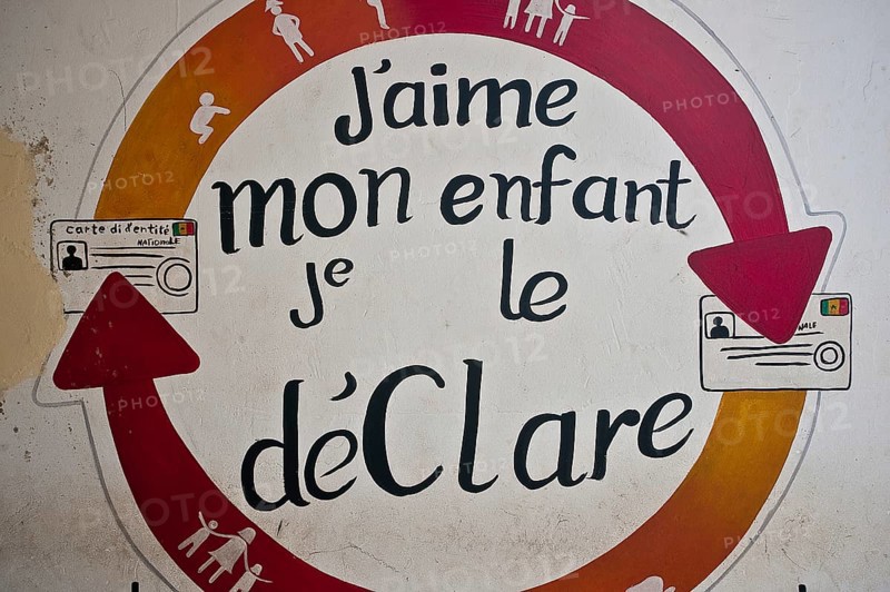 Message written in french language meaning I love my child, I register him. Message written on the outer wall of a hospital to enjoin the parents to register their children Senegal