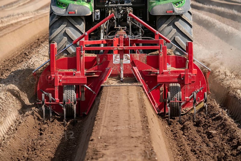 A farmer builds asparagus ridges on a field with the help of an asparagus tiller, in which the asparagus then grows, Dormagen, North Rhine-Westphalia, Germany, Europe
