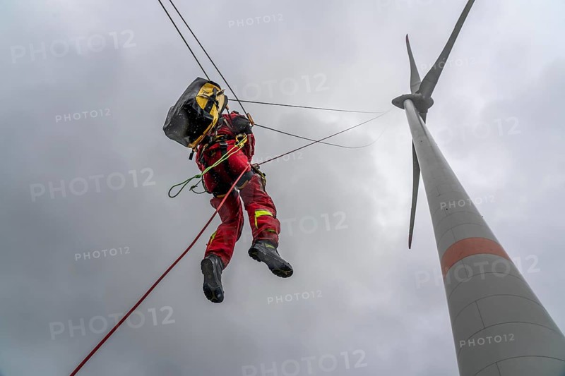Height rescuers from the Oberhausen fire brigade practise abseiling from a wind turbine from a height of 150 metres after rescuing an accident victim from the nacelle, Issum, North Rhine-Westphalia, Germany, Europe