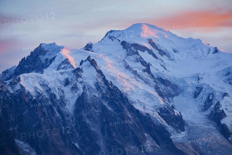 Alpenglow at the summit of Mont Blanc with Aiguille du Midi in the foreground, Savoie, France, Europe