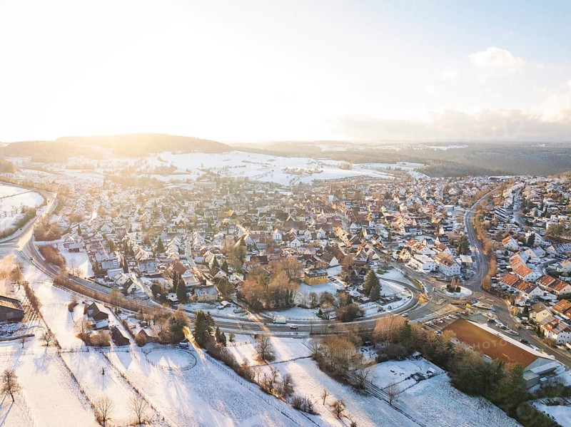 Snow-covered village in a vast landscape with low sun, Calw- Stammheim, Black Forest, Germany, Europe