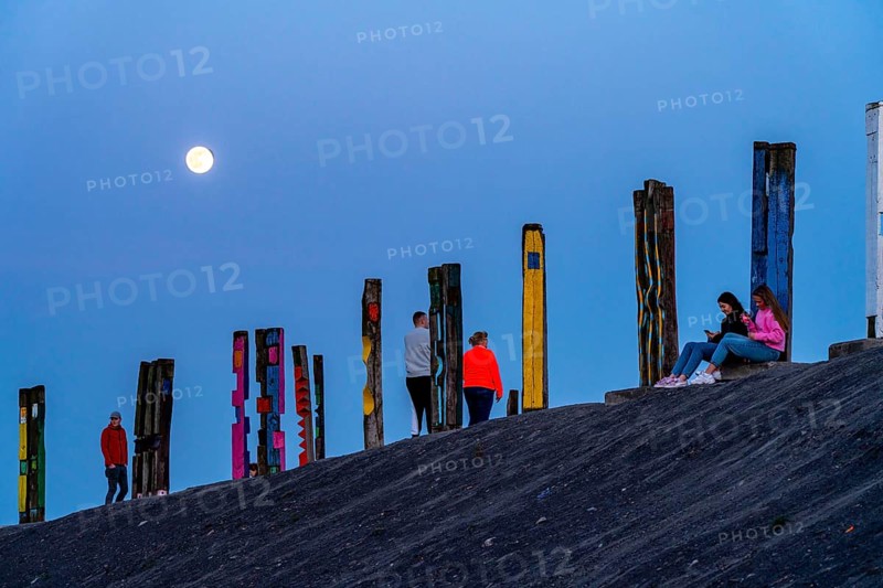 The Haniel spoil tip, 185 metre high spoil tip, at the Prosper Haniel mine, closed in 2019, artwork Totems by the sculptor Augustin Ibarrola, full moon, Bottrop, Germany, Europe