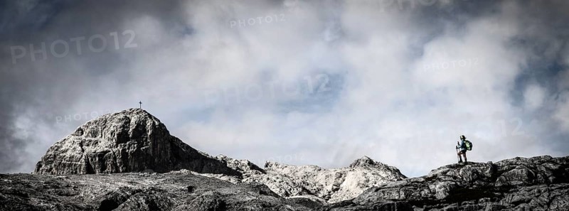 Mountaineer on rocky plateau with summit in the background, Tschagguns, Rätikon, Montafon, Vorarlberg, Austria, Europe