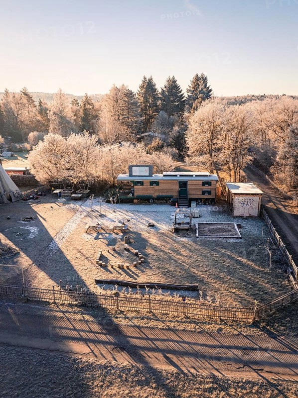 Caravan and tipi surrounded by frost-covered trees in the morning sun, Kita, Gechingen, Hecken und Gäu Region, Landkreis Calw, Schwarzwald. Germany