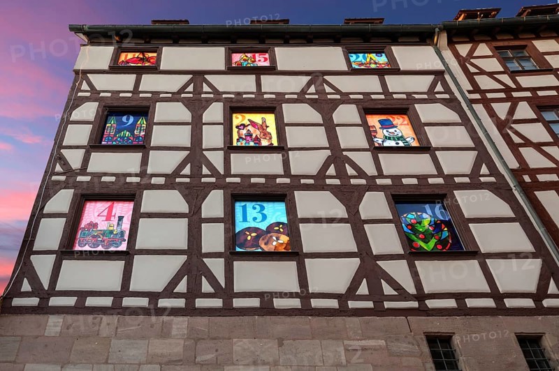 Side facade of the Pilatushaus with 9 windows of the Advent calendar created by the Alstadtfreunde Nürnberg, Tiergärtnertorplatz, Nuremberg, Central Franconia, Bavaria, Germany, Europe