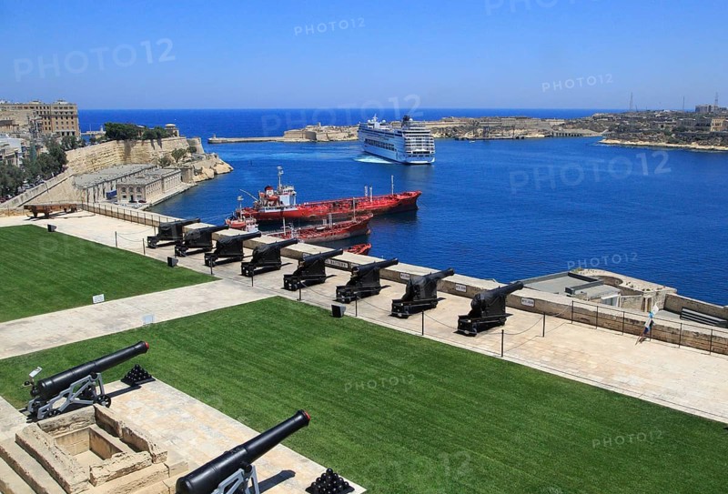 Merchant shipping and cruise ship arriving in Grand Harbour, Valletta, Malta from gun Saluting Battery platform