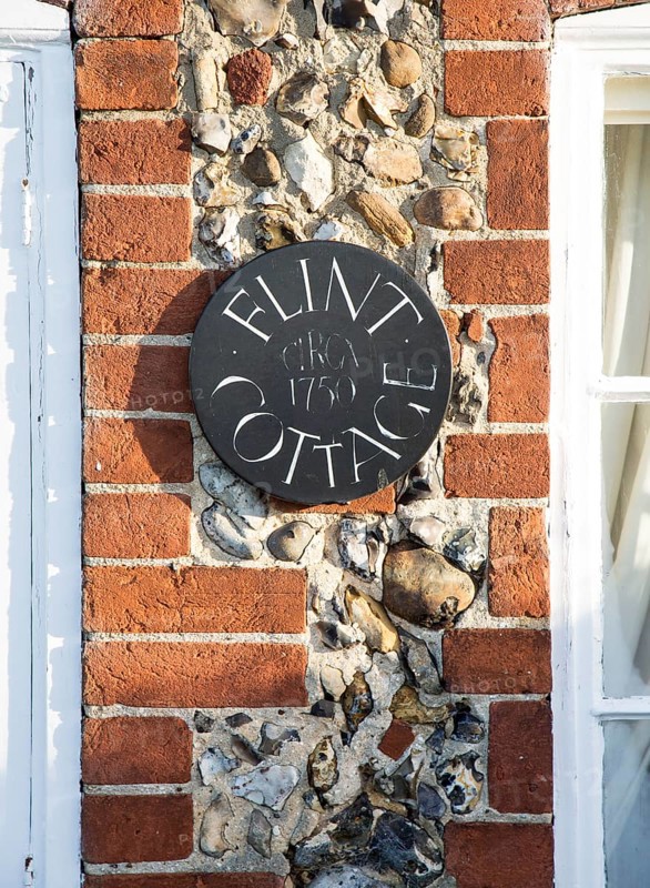 Flint Cottage building detail showing use of red brick and flints at Pettistree, Suffolk, England, UK