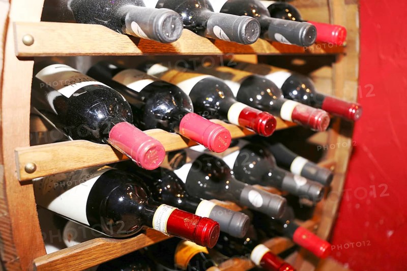 Wine cellar with red wine bottles