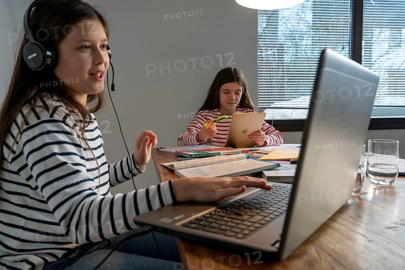 Homeschooling, during the lockdown in January 2021, children learning at home for school, a girl in video lessons, video chat, with here class, a girl learning with a tablet computer, school closures, distance learning, effects of the corona crisis in Germany