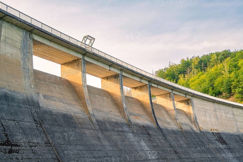 A large concrete dam rising against the sky, surrounded by green nature, Rappbodetalsperre, Harz Mountains, Germany, Europe