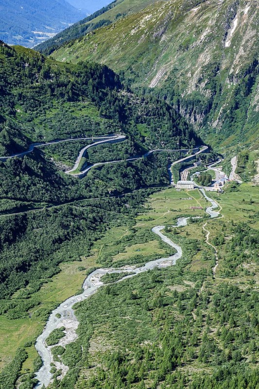 View from elevated position like aerial view on left Furka road pass road to alpine pass Furka pass centre river Rhone in background place village Gletsch, Alps, canton Valais, Switzerland, Europe