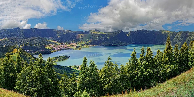 Impressive panorama of the crater lake Lagoa Azul with lush green colours and a blue sky, crater circular hiking trail, Caldeira das Sete Cidades, Lagoa Azul, Sao Miguel Island, Portugal, Europe