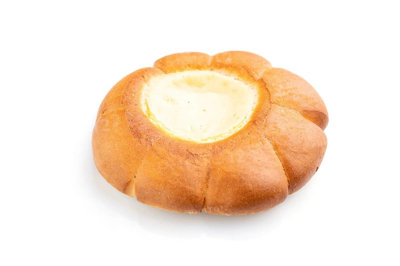 Sour cream bun isolated on white background. Side view, close up