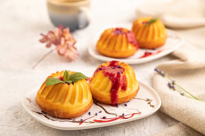 Semolina cheesecake with strawberry jam, lavender, cup of coffee on gray concrete background and linen textile. side view, close up, selective focus
