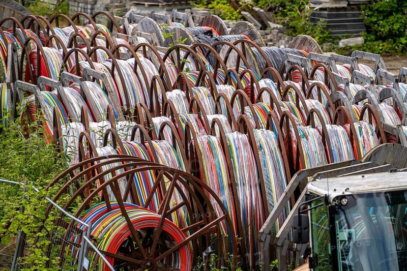 Cable drums with conduits for fibre optic cables, in a storage yard, North Rhine-Westphalia, Germany, Europe