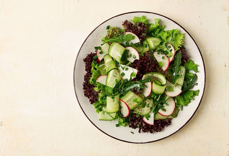 Vegetable salad, radishes and cucumbers, radish micro-greens, lettuce leaves, green onions, homemade, no people