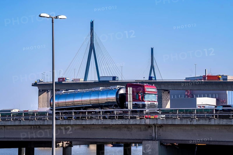 The Köhlbrand Bridge in the port of Hamburg, in front traffic on the A7 motorway, spans the 325 m wide Köhlbrand, an arm of the Süderelbe, the bridge is over 3600 metres long, 53 metres above the water, piers 135 m high, more than 30, 000 vehicles use the B3 bridge daily, important connection to the port, it is dilapidated, to be rebuilt, Hamburg, Germany, Europe