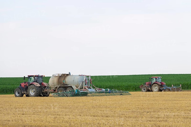 Farmers spread liquid manure on harvested grain field and plough it up, Swabian Alb, Baden-Württemberg, Germany, Europe