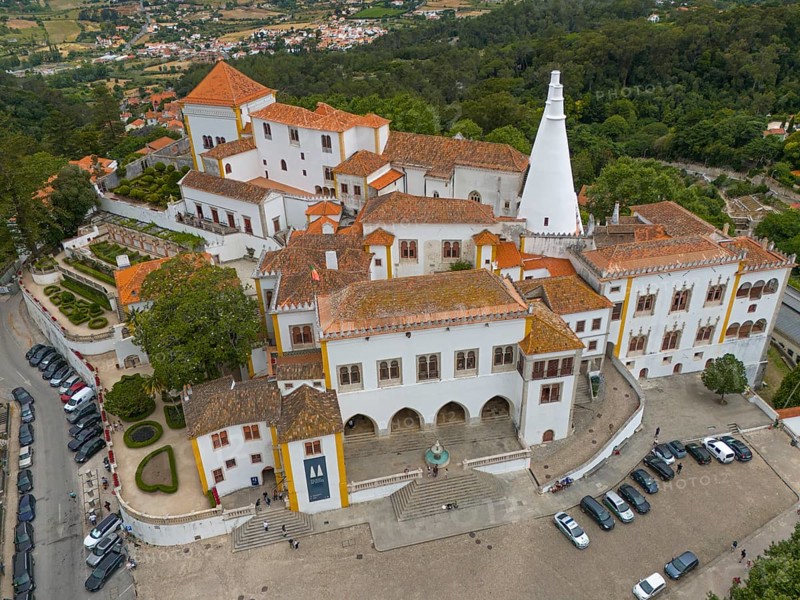 Aerial view of a historic castle with striking white towers and surrounding gardens, Royal Palace, Palácio Nacional de Sintra, National Palace, Sintra, Lisbon, Portugal, Europe