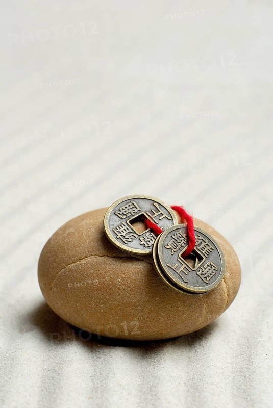 Stone and Chinese lucky coins, coins, lucky coins, lucky coin, coin, in sand