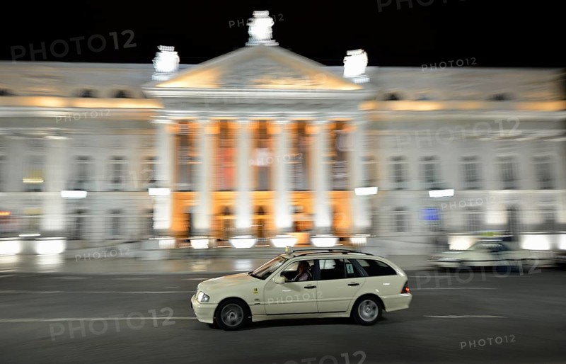 Taxi at night in front of the Teatro Dona Maria II National Theatre in Rossio Square, or Praça Dom Pedro IV, Lisbon, Portugal, Europe