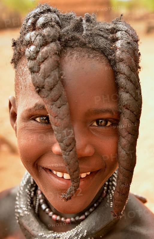 Smiling Himba girl with typical hairstyle, Omuramba, Kaokoland, Kunene, Namibia, Africa