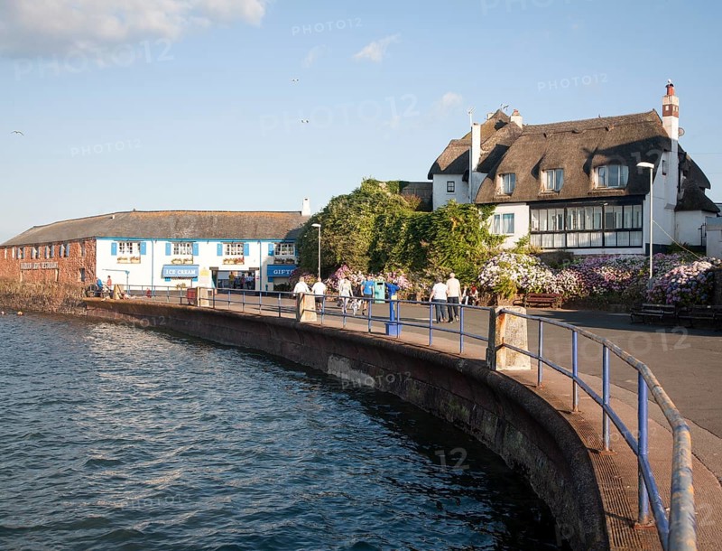 Thatched historic houses on the seafront at Paignton, Devon, England, UK