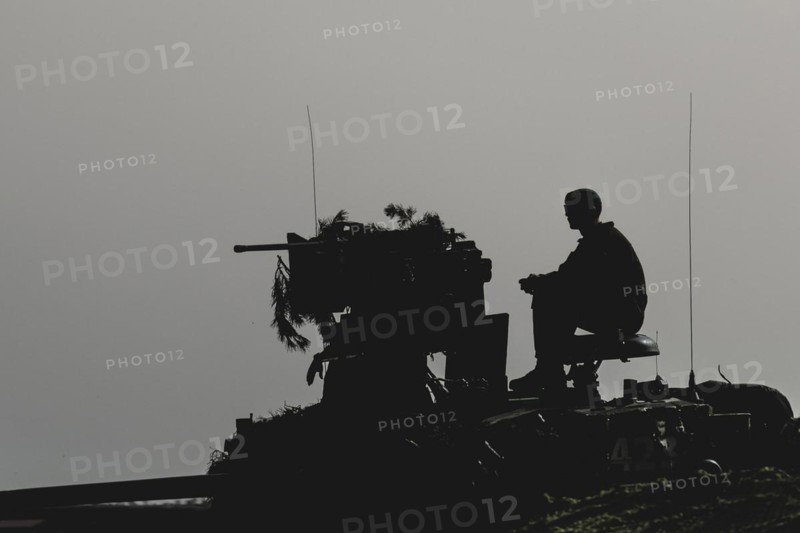 A soldier sits on a tank, taken as part of a Bundeswehr exercise with armed forces from Norway and the Czech Republic during the 'Wettiner Schwert' exercise as part of Quadriga 2024 in the training town of Schnöggersburg, 8 April 2024
