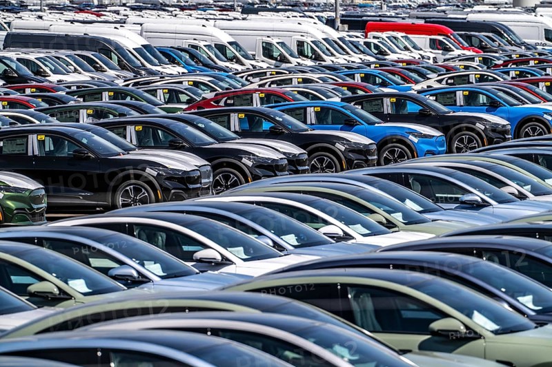 Storage area for new cars in the port of Vlissingen-Oost, vehicles are temporarily stored on over 100 hectares to ship them from Europe to the United Kingdom, Ford cars, others such as models from the Chinese car manufacturer BYD are delivered from here in Europe, wind farm, Netherlands