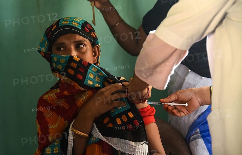 Beneficiaries receives dose of COVID-19 coronavirus vaccine in a vaccination centre at a village in Barpeta, Assam, India on 20 September 2021