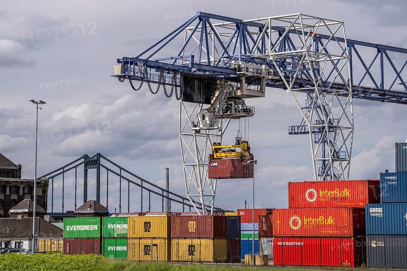 Container terminal at the Rhine port of Krefeld, inland port, 4th largest public port in North Rhine-Westphalia, trimodal handling of goods, goods, containers, general cargo, in the background the Krefeld-Uerdingen bridge over the Rhine, North Rhine-Westphalia, Germany, Europe