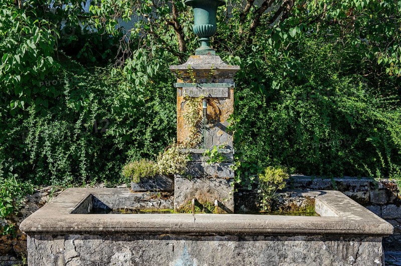 Old historic fountain with curved tap Water spout for permanent drinking water supply Water supply clean drinkable water for human consumption Food with sign Eau potable, above goblet Cup vase for without flowers, Les Planches-prés-Arbois, Bourgogne-Franche-Comté, Département Jura, France, Europe