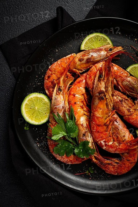 Langoustines, Australian, freshly frozen on ice, top view, lime and greens