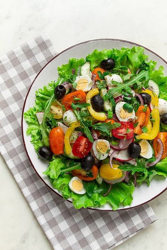 Vegetable salad, with quail eggs and olives, fresh, close-up, no people
