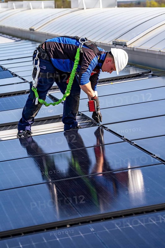 Installation of solar modules on the roof of a commercial enterprise, over 400 photovoltaic modules are installed on the roof, North Rhine-Westphalia, Germany, Europe