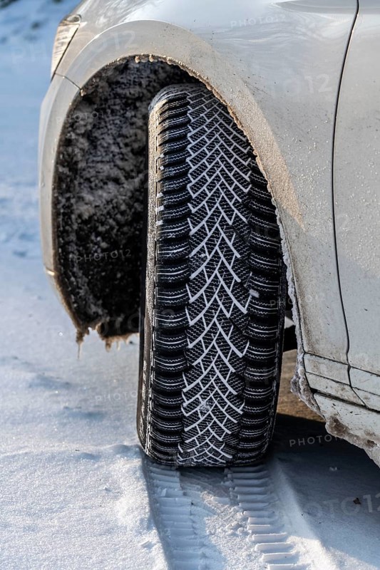 Winter tyres, driving on a road with snow cover, grip on the snow thanks to the special tread and rubber compound, the tyre for winter