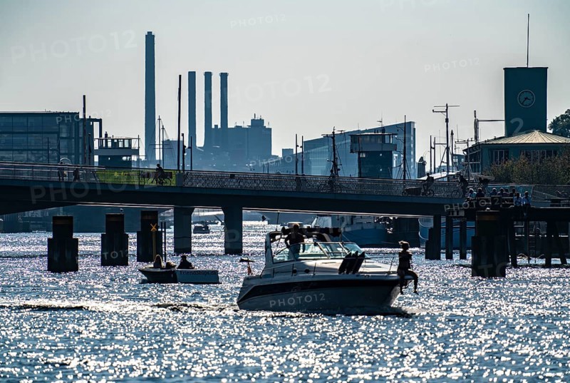 View over the harbour, the pedestrian and cycle bridge Inderhavnsbroen, skyline at Sydhavnen in the background, chimneys of the combined heat and power plant H.C. Ørstedsværket, Copenhagen, Denmark, Europe