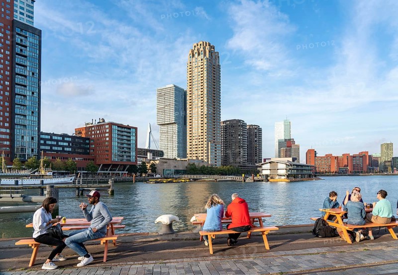 View of the skyline of Rotterdam, from the Fenix Food Factory, market hall and restaurants, on the Nieuwe Maas, river, skyscrapers at the Kop van Zuid neighbourhood, Netherlands