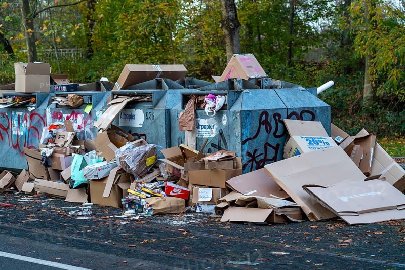 Overfilled waste paper containers, despite the overcrowding, people have put their waste paper next to them, Essen, North Rhine-Westphalia, Germany, Europe