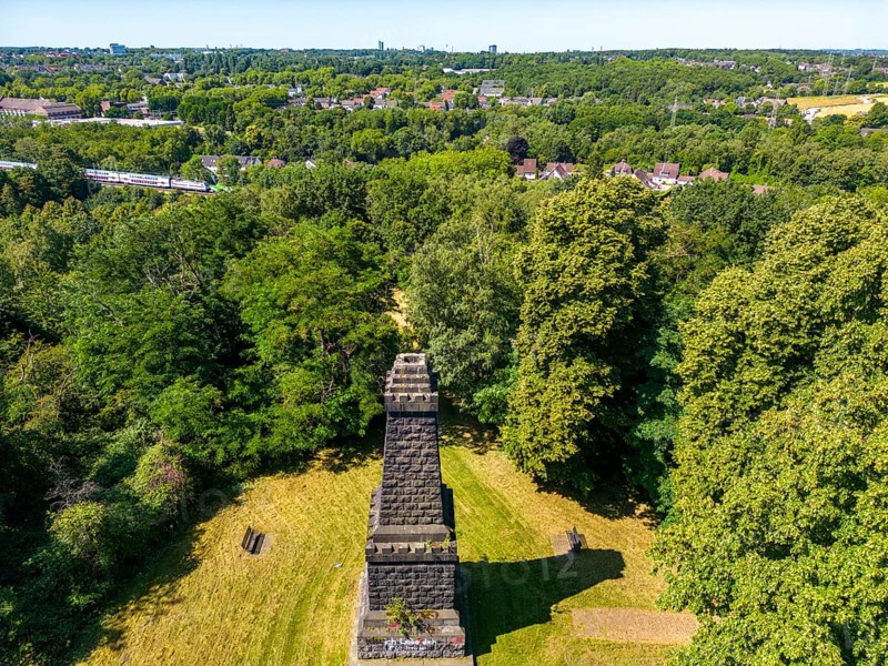 The Mechtenberg in Essen, one of the few natural elevations from the ice age in the Ruhr area, was once 100 metres above sea level, but due to mining subsidence it is now only around 80 metres above sea level, Bismarck Column, view to the west towards Essen, part of the Mechtenberg Landscape Park, North Rhine-Westphalia, Germany, Europe
