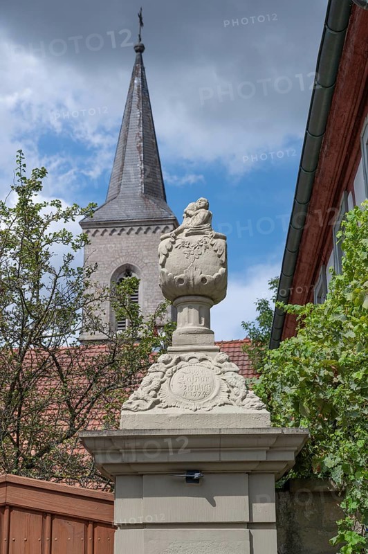 Vase attachment on a courtyard gate, 1774, behind the tower of the parish church of St John the Baptist, Hüttenheim, Lower Franconia, Bavaria, Germany, Europe