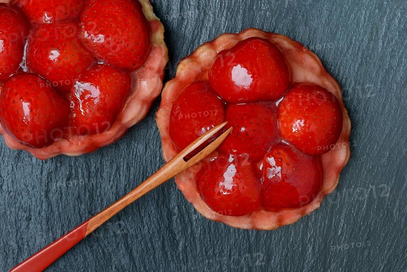 Topped strawberry tarts with a fork