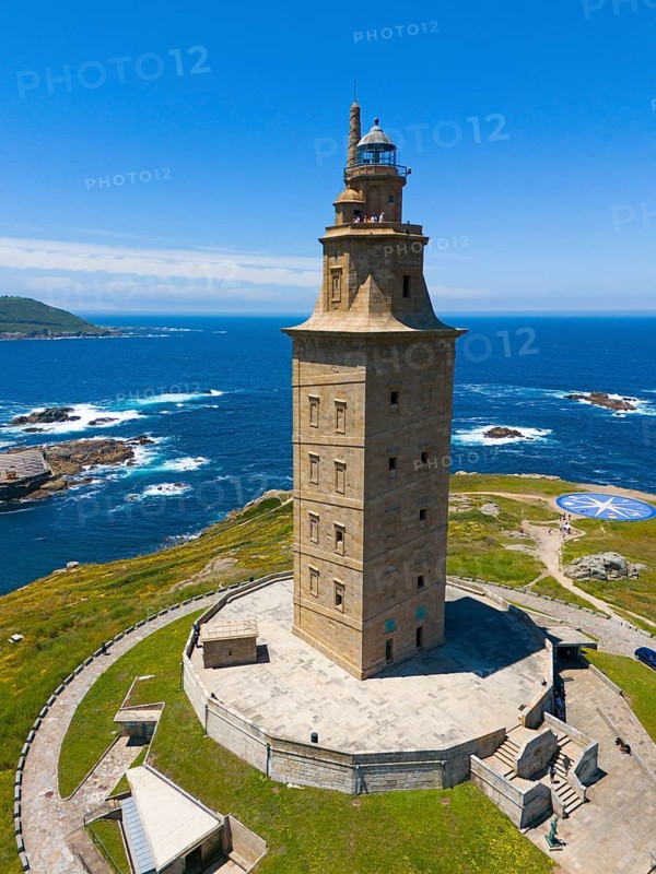 High lighthouse on the coast, rising proudly above the blue sea and the surrounding green areas, aerial view, Torre de Hércules, Torre de Hercules, Roman Tower of Hercules, A Coruña, A Coruna, La Coruña, La Coruna, Galicia, Spain, Europe