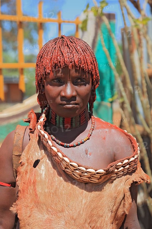 Southern Ethiopia, woman of the Hammer people in Dimeka, dress made of goatskin and hair dyed with a mixture of fat and ochre-coloured clay, Ethiopia, Africa